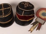 three hats with ribbons and ribbons are sitting on a white surface