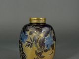 a small vase with flowers painted on it on a table