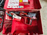a red tool box with tools in it on the floor