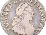 a close up of a silver coin with a woman on it