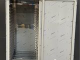 an image of a metal cabinet with a door open on a concrete floor
