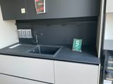 a kitchen with a sink and a refrigerator in it