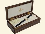 a wooden box with a watch inside of it