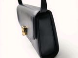 an image of a black purse on a white background