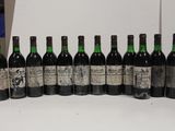 six bottles of wine are lined up in a row on a table