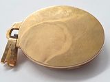 a gold locke with a tassel hanging from it ' s side