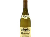 the bottle of wine is sitting on a white surface