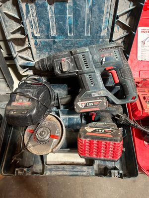 the tools are sitting in the case on the floor next to the tool box