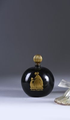 pair of black and gold glass perfume bottles with a gold lid