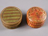 pair of decorative wooden boxes with floral designs on them on a gray surface