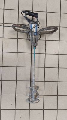 a metal pole with a blue handle on a tiled floor