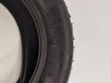 a close up of a tire on a white wall