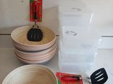 many bowls, spatulas, and other kitchen utensils on the counter