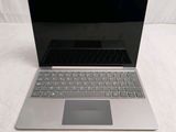 an open laptop computer sitting on top of a white surface