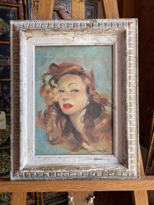 an oil painting of a woman with red hair in a white frame