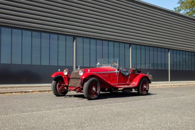 a red car that is parked in front of a building