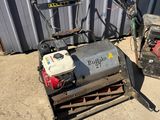 a small machine that is sitting on the ground next to a building