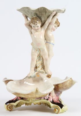 a figurine that is sitting on top of a shell