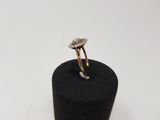 a close up of a diamond ring on a black ring holder