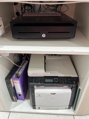 a printer that is sitting on top of a shelf