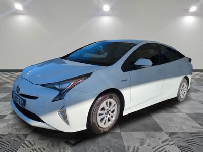 a white toyota prius parked on a checkered tile floor