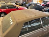many cars parked in a garage next to each other