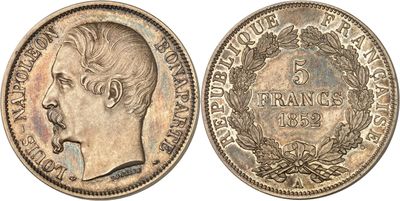a silver coin with an image of a man ' s face on it