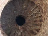 a hole in the middle of a stone vase