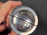 a person holding a silver object in their hand