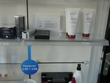 a shelf with a lot of beauty products on it