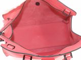 the inside of a pink purse with a zipper on the inside