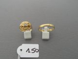 two rings and a price tag on a table with a price tag