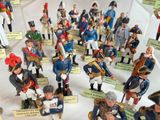 many figurines of different sizes and colors on display