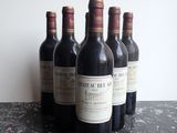 several bottles of wine are lined up on a table