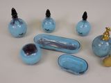 a group of blue glass objects on a white table