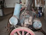 an old fashioned steam engine sitting in a garage