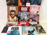 the walking dead comic books are stacked on a table