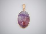 a close up of a purple and gold pendant on a white background