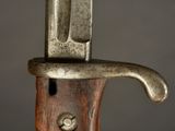 a close up of a knife on a wooden handle