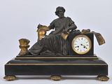 a statue of a woman sitting on top of a clock