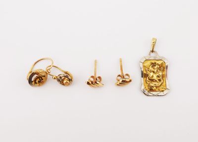 three pairs of gold earrings and a pendant