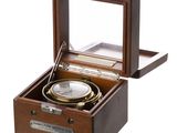 an image of a wooden box with a compass inside of it