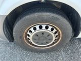 a white car with a flat tire on the street