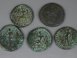 four ancient roman coins with a man on one side and a woman on the other