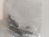 two screws in a plastic bag on a table