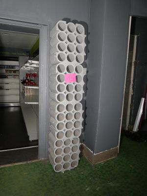 a large stack of wine bottles in the corner of a room