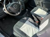 a car with a seat and a bag in the back