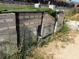 a wooden fence that has grass growing on top of it