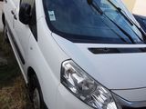 a white van parked in front of a building