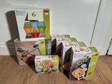 four boxes of toys sitting on the floor next to each other